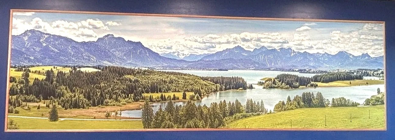 Vast Image Gigapixel panoramic landscape vertical wall print of mountains, forests, lakes, and green fields under a cloudy sky.
