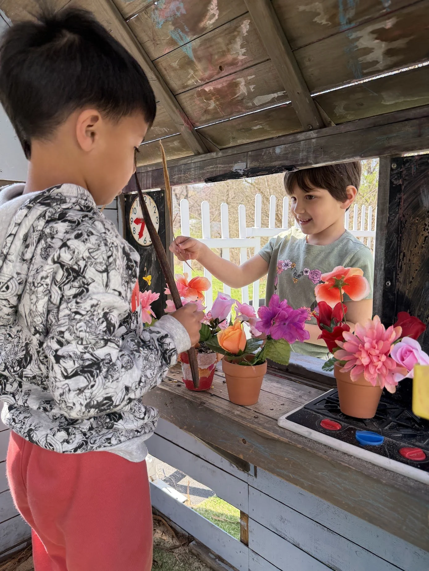 children playing in a pretend outdoor flower shop