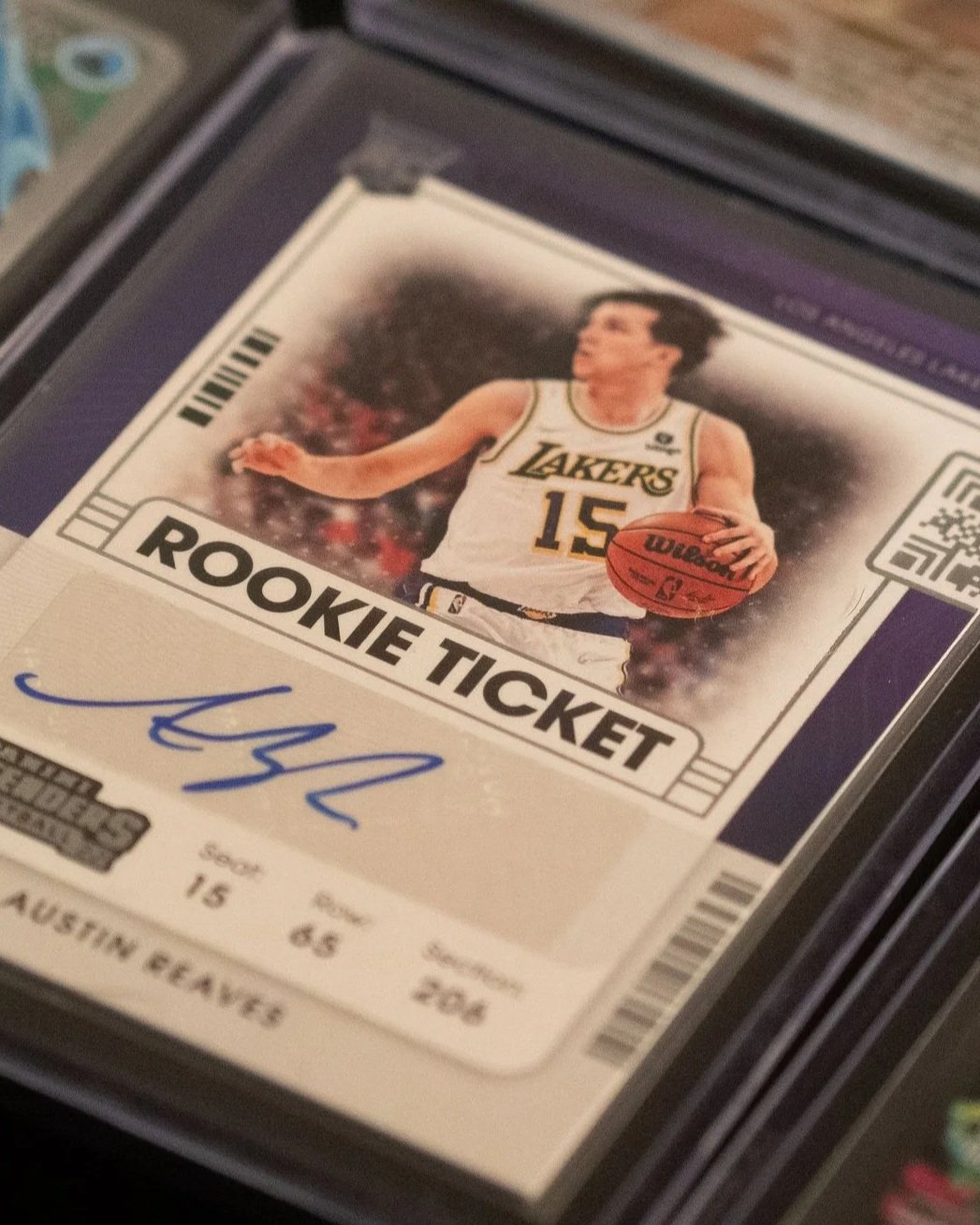 Sports trading card of a basketball player in a Los Angeles Lakers jersey holding a basketball, labeled 'ROOKIE TICKET'.