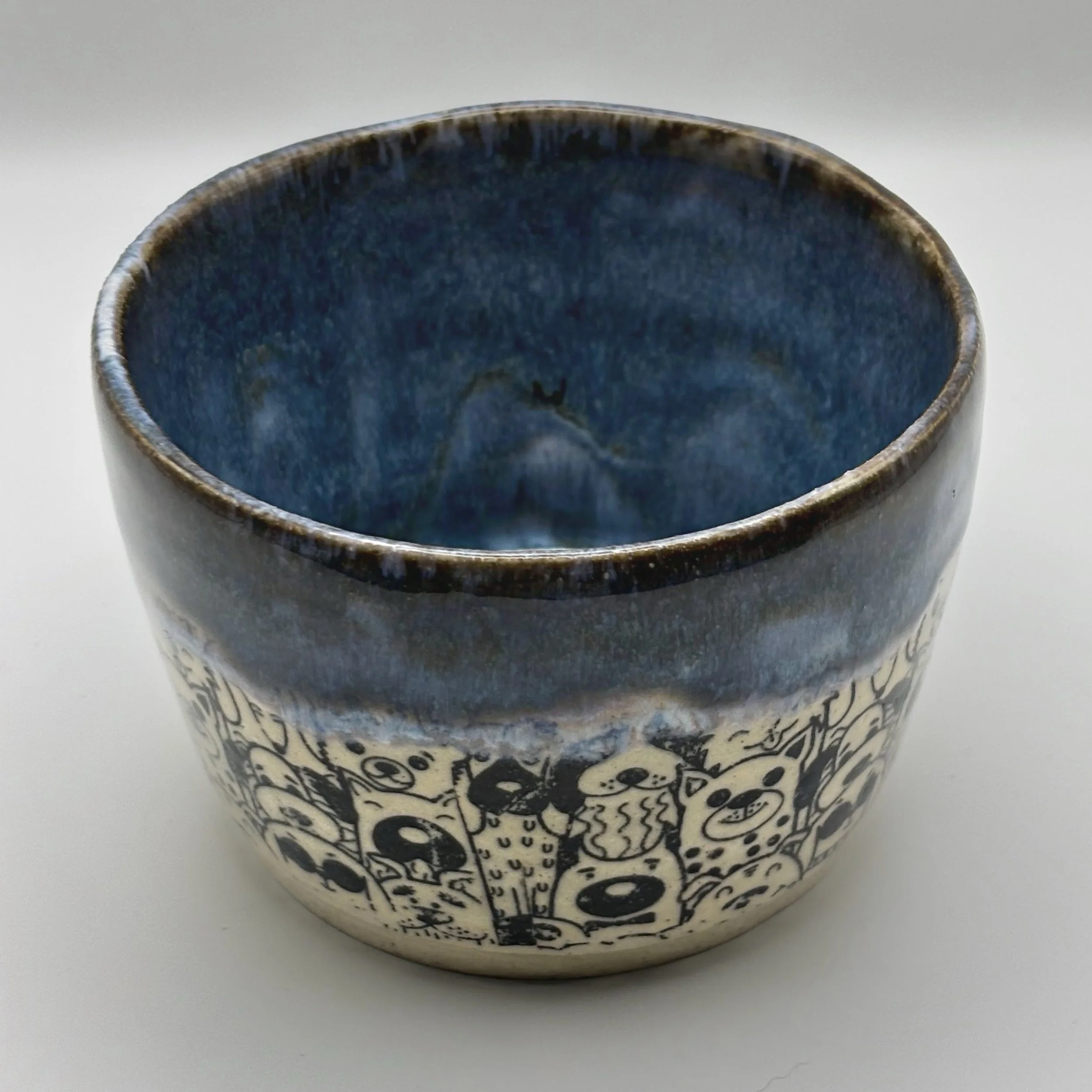 Handmade Ceramic cup with black and white abstract pet patterns.