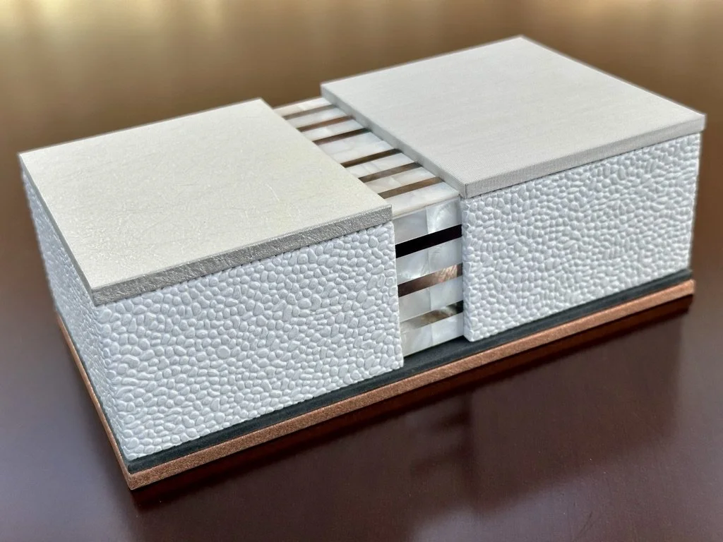 A modern table centerpiece with two rectangular boxes and a wooden base.