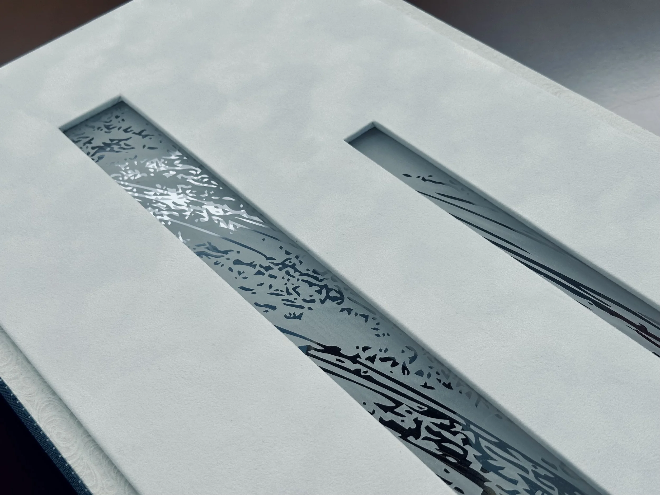 Close-up of a white object with cut-out shapes revealing a patterned interior.