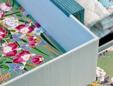 A box with colorful patterned fabric or paper inside.