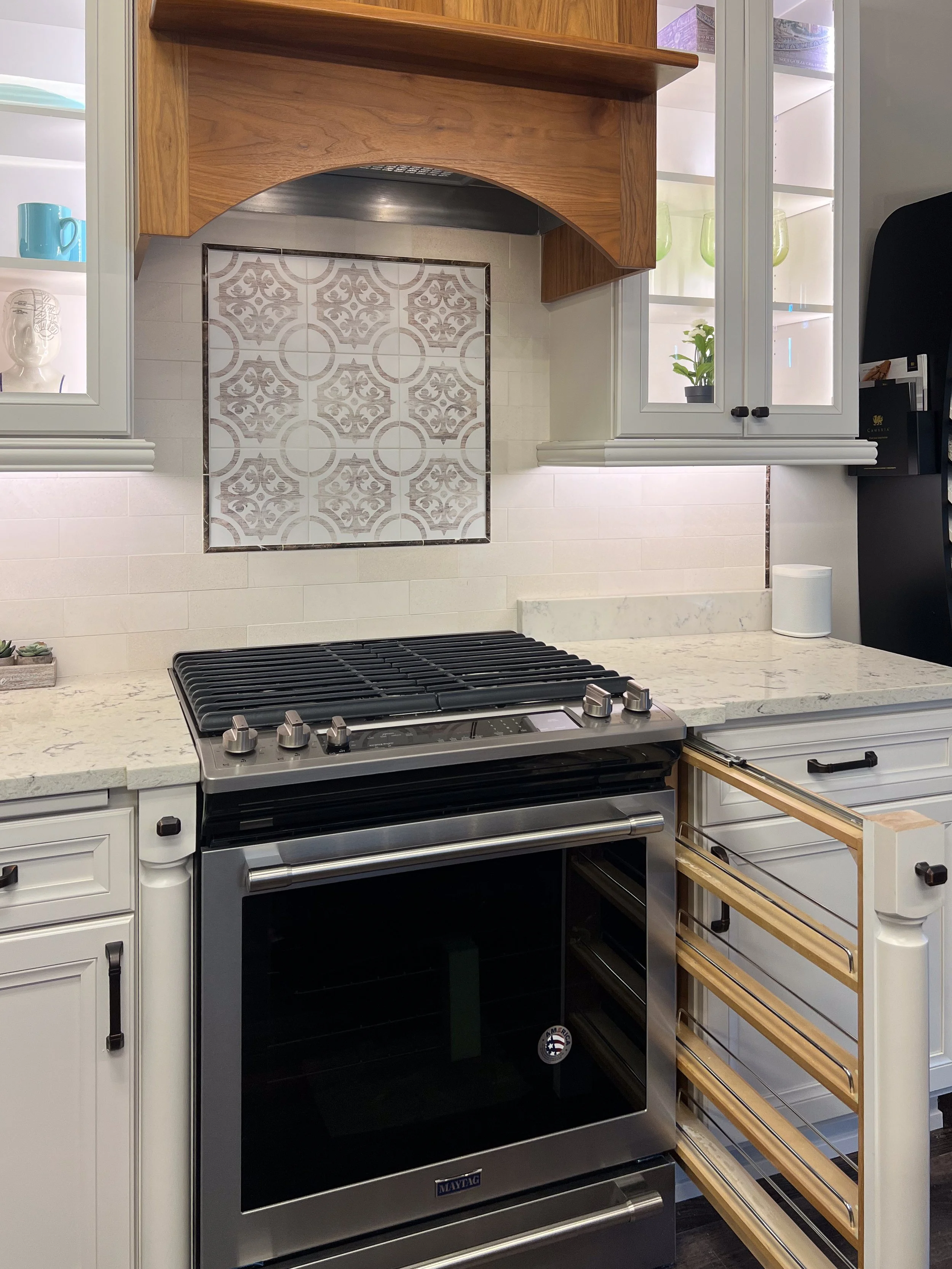 Decorative Column Pull-Outs  |  
Smart kitchen engineering that transforms ornamental cabinet legs into functional storage. These slim filler pull-outs blend seamlessly into the decorative posts flanking the range to hold spices and cooking oils comp