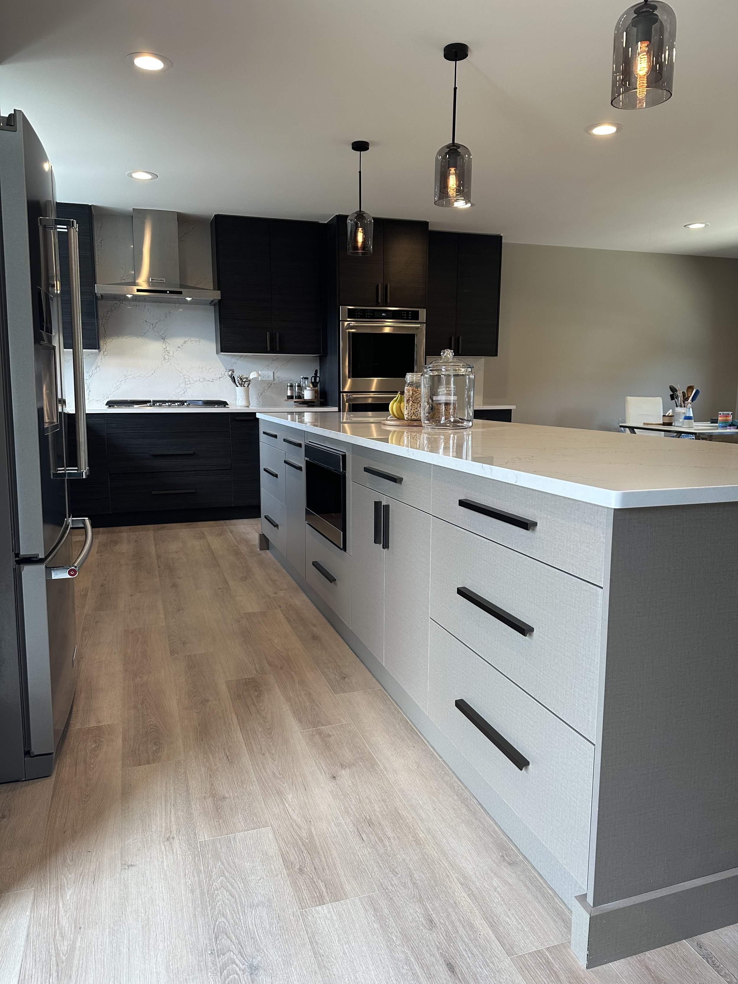 Experience the allure of our two-tone kitchen, marrying dark and light tones harmoniously. The elegance is heightened by a stunning countertop and full-height backsplash, transforming your culinary space with captivating contrasts.