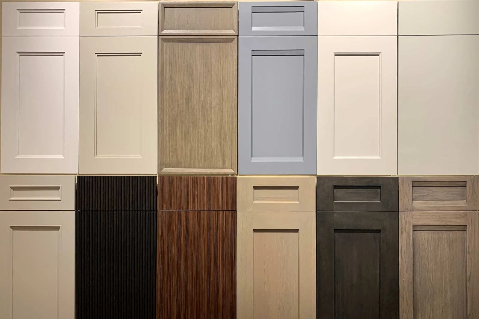 Various kitchen cabinet door samples in different colors and finishes.