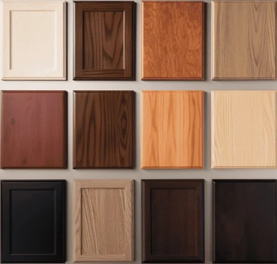Different wood cabinet door samples with various finishes and colors.