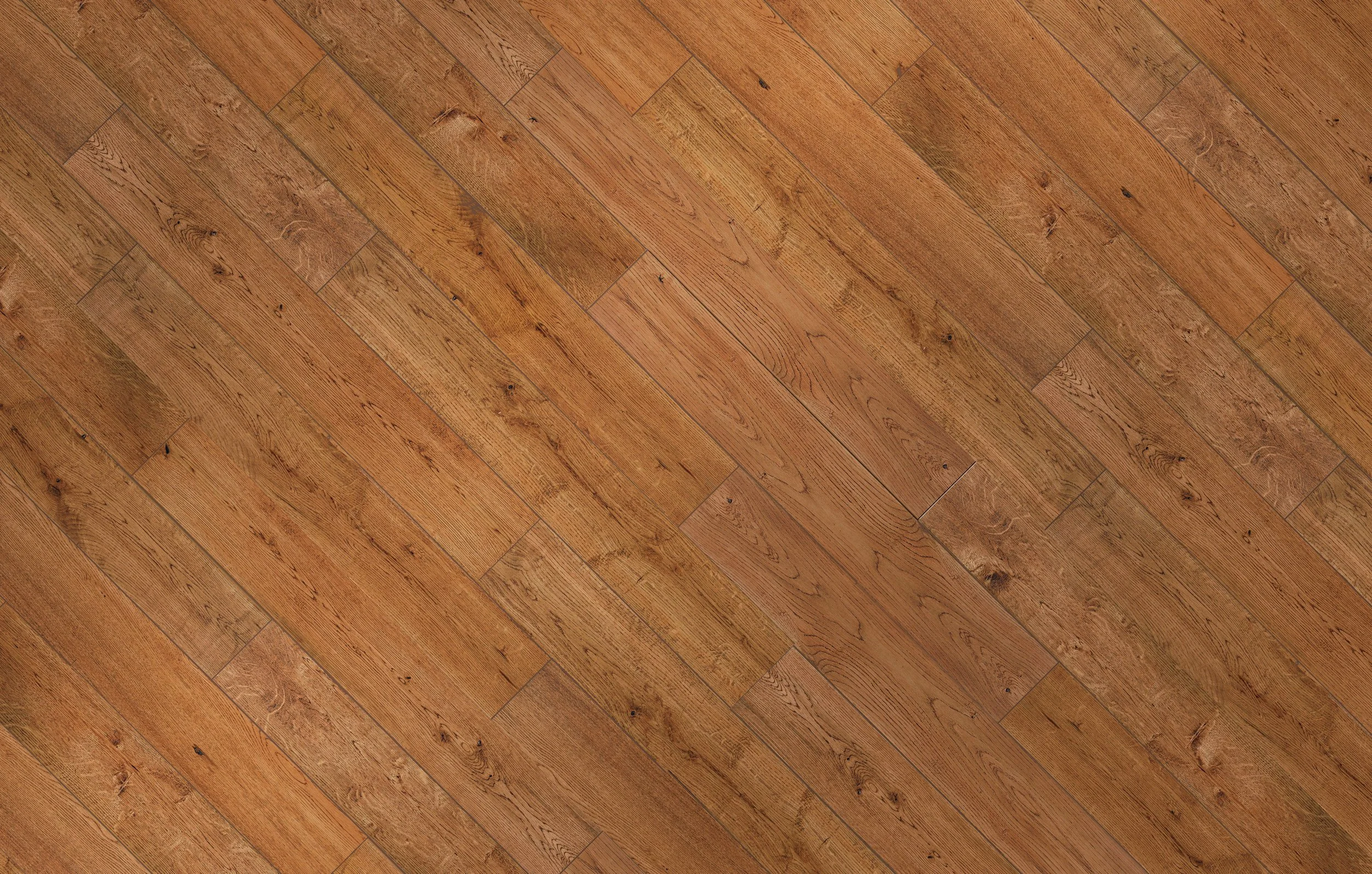 Wooden floor with a herringbone pattern in a warm, brown color