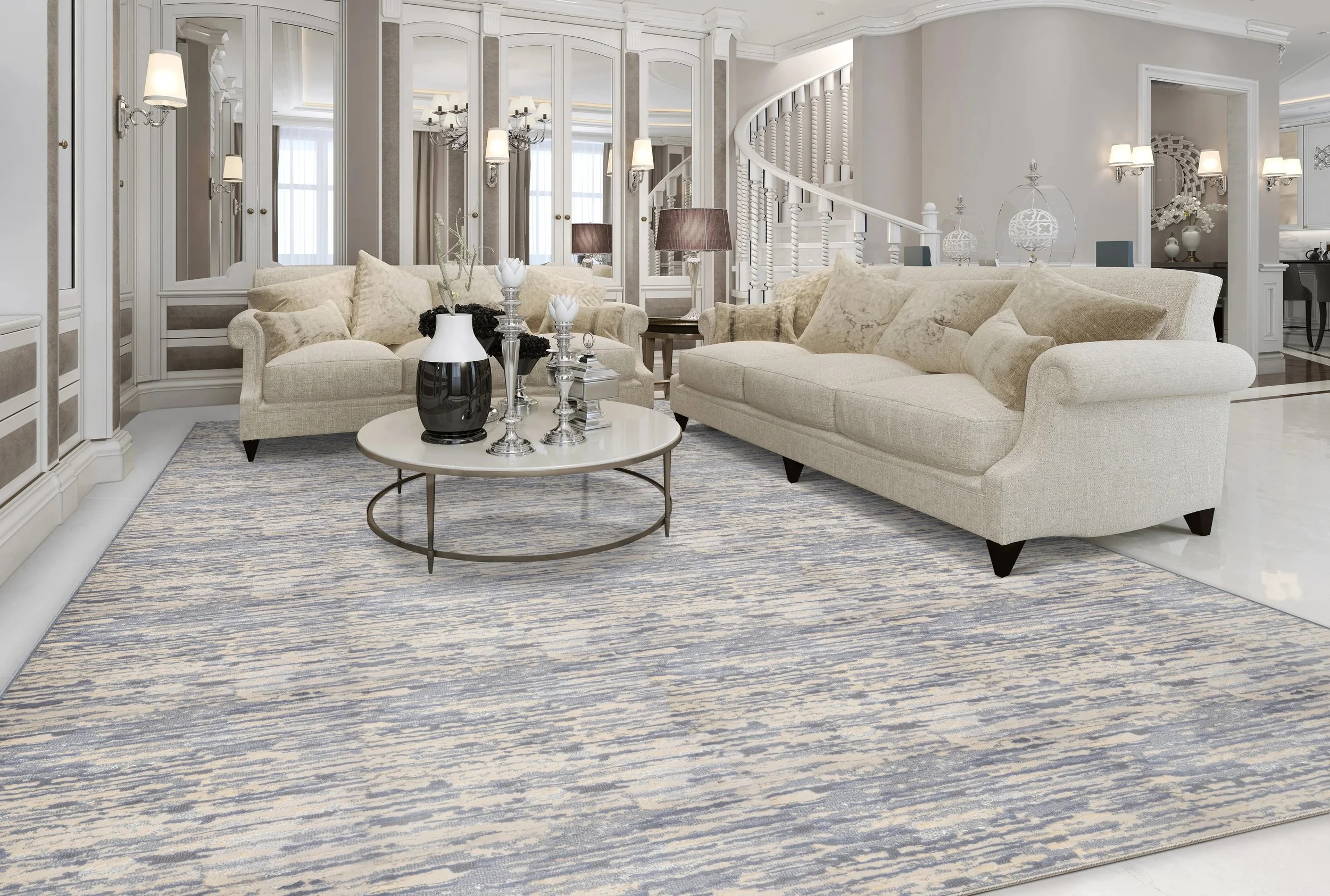 Elegant living room with beige sofas, mirrored walls, spiral staircase, round coffee table, and patterned rug.
