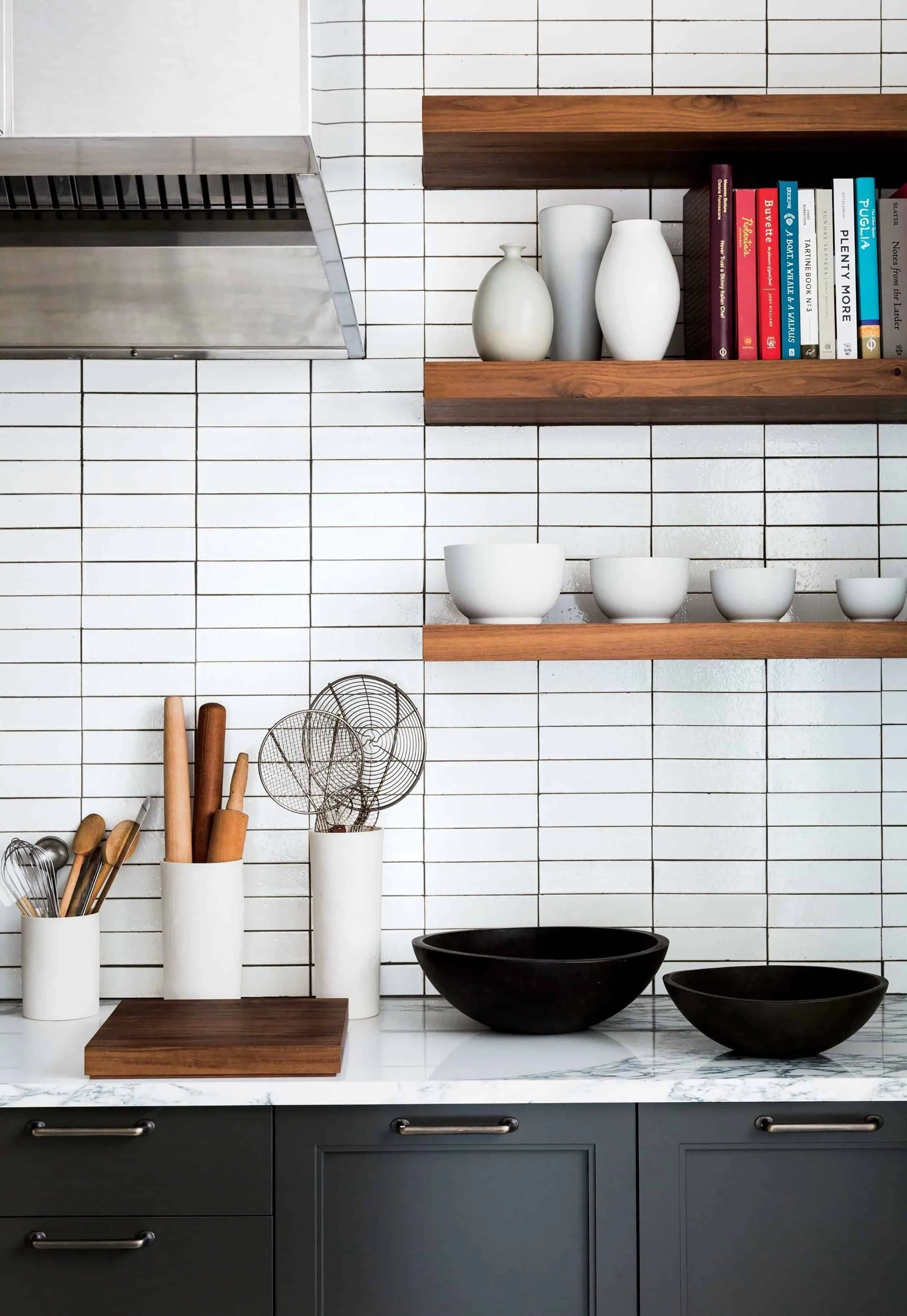 In this photo, a kitchen showcases a chic white horizontal stacked tile backsplash, offering a clean and modern design that contributes to a bright and timeless culinary atmosphere.