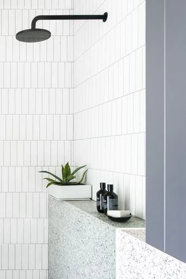 In this bathroom shower, a vertical stack offset pattern takes center stage, bringing a visually interesting design to the space. The arrangement adds a touch of contemporary elegance, creating a stylish focal point for a rejuvenating shower.