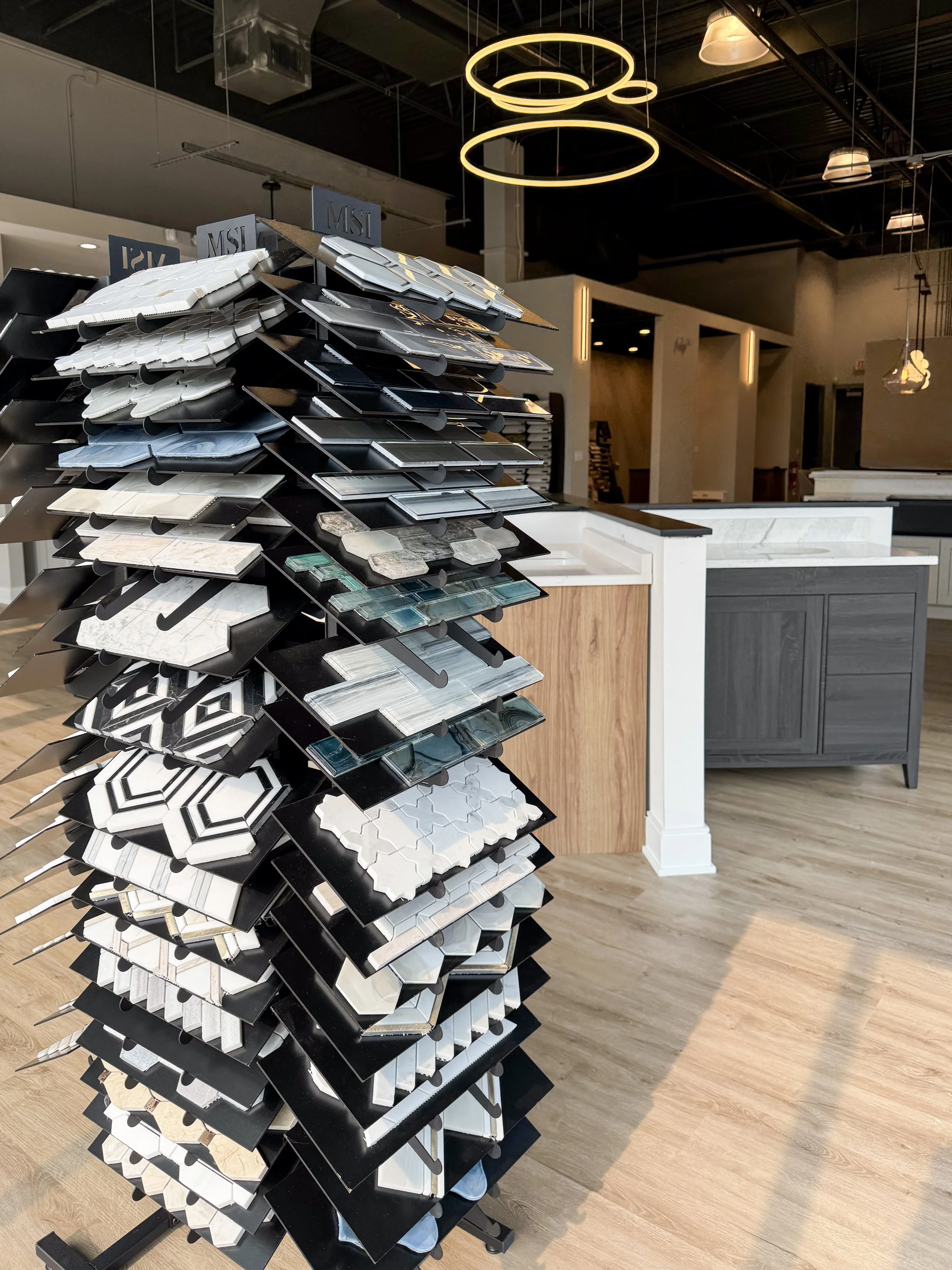 Display stand with various tile samples in a showroom.