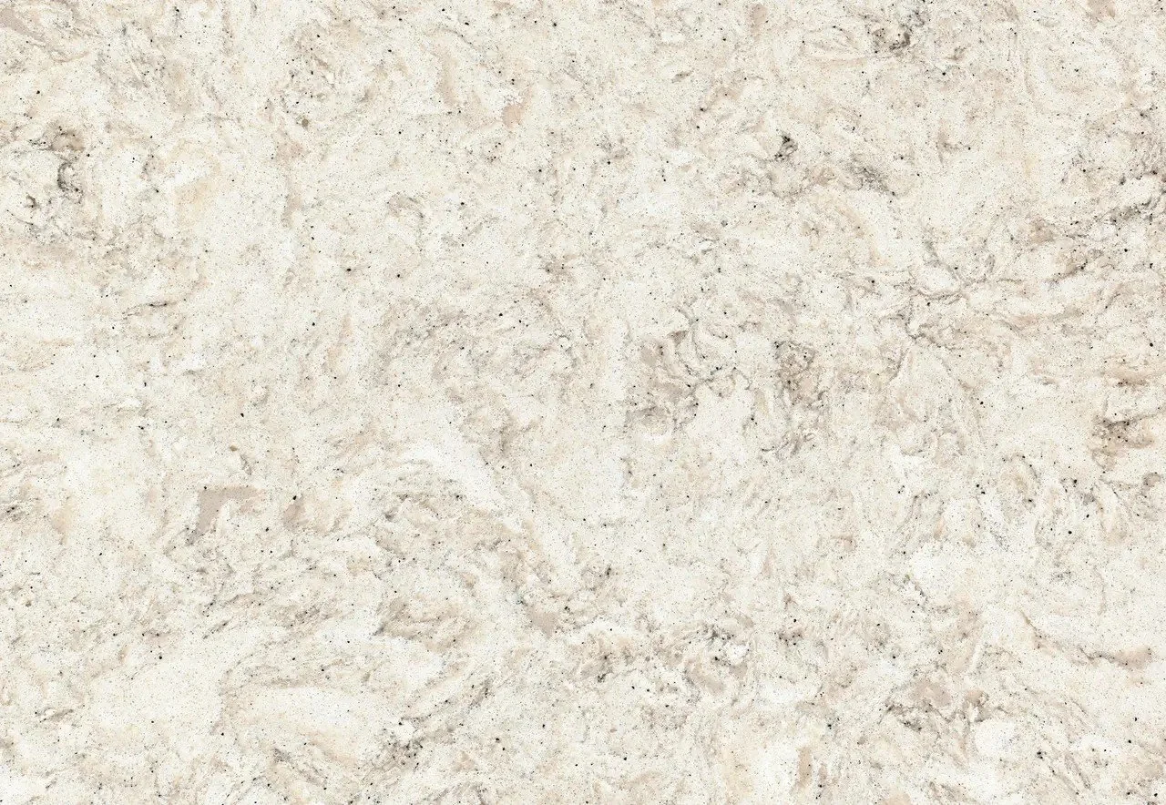 Close-up of Cambria's Warwick quartz featuring soft, sandy swirls with warm beige, tan, and speckled charcoal accents.