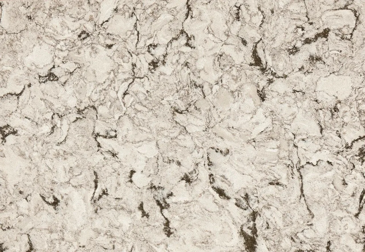 Close-up of Cambria's Axbridge quartz countertop with bold charcoal veining over a warm taupe and cream background.