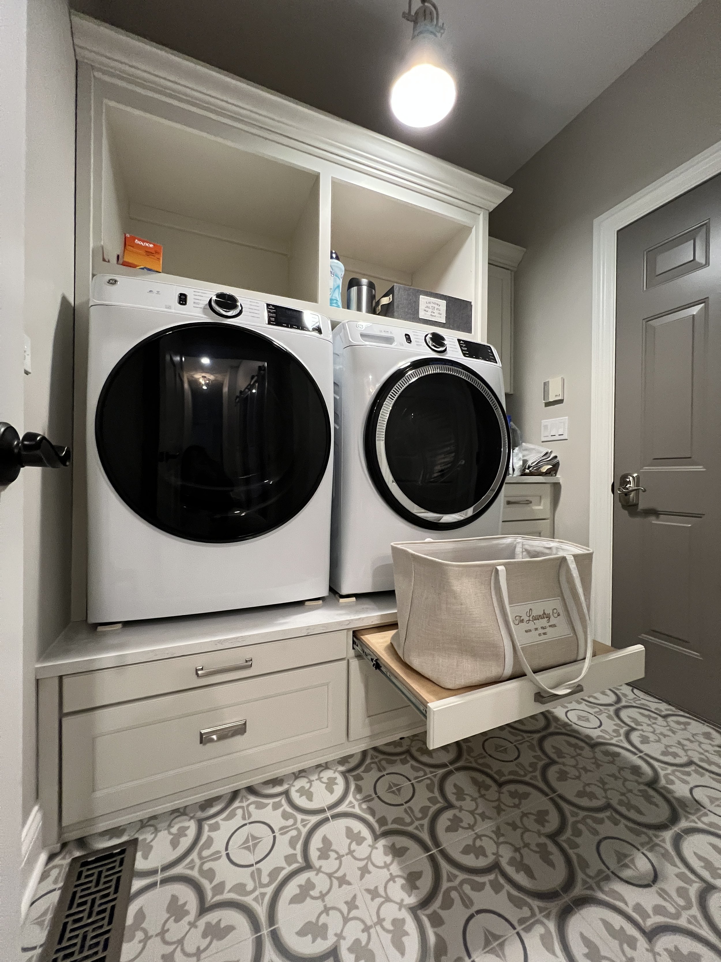 Pull-Out Laundry Basket Platform  |  A heavy-duty, smooth-gliding pull-out shelf designed to hold laundry baskets at an ergonomic height, built into custom raised washer/dryer cabinetry. Crafted for the Harris custom remodel.  |  [Click Image to View