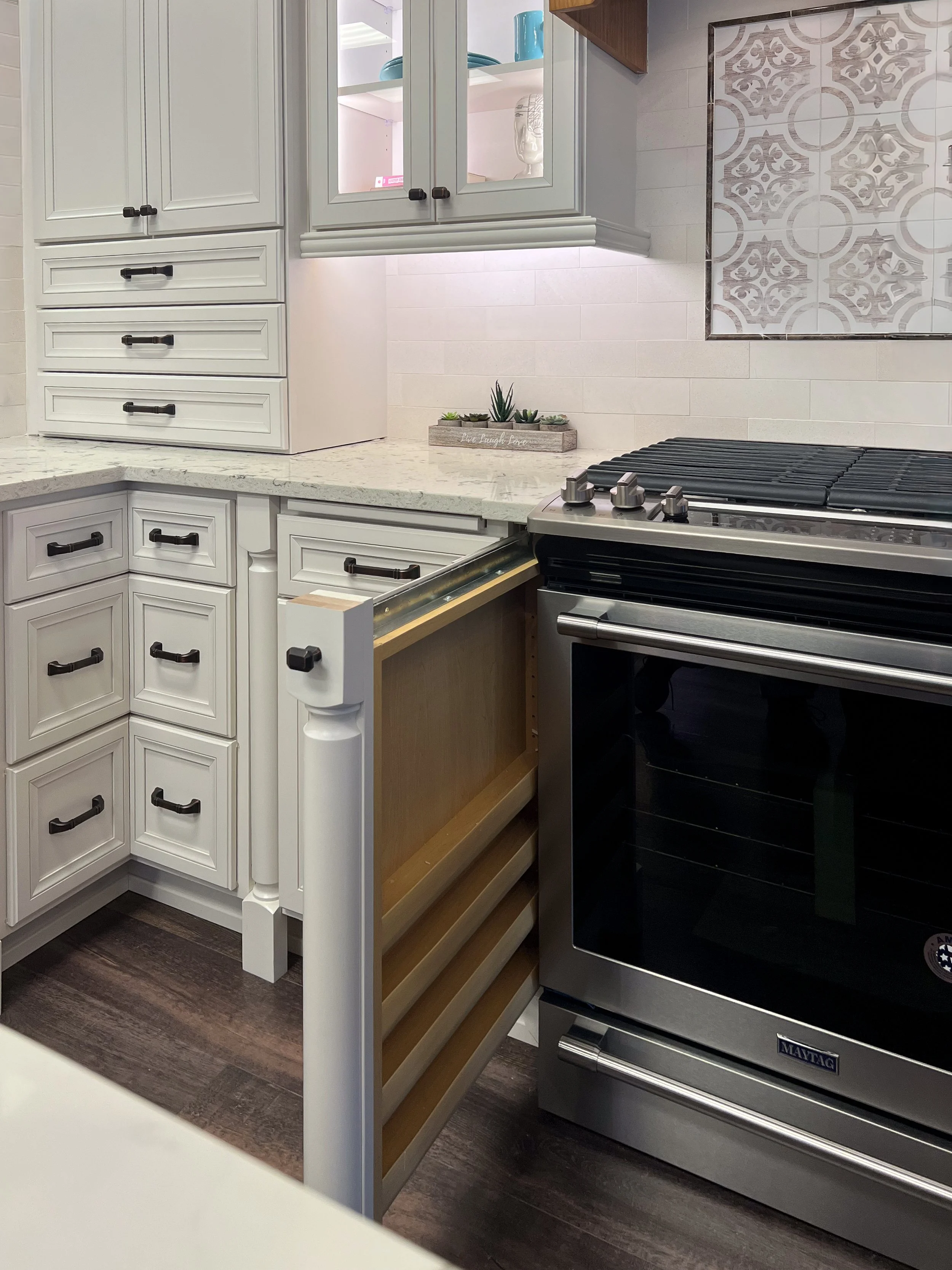 Decorative Column Pull-Outs  |  
Smart kitchen engineering that transforms ornamental cabinet legs into functional storage. These slim filler pull-outs blend seamlessly into the decorative posts flanking the range to hold spices and cooking oils comp