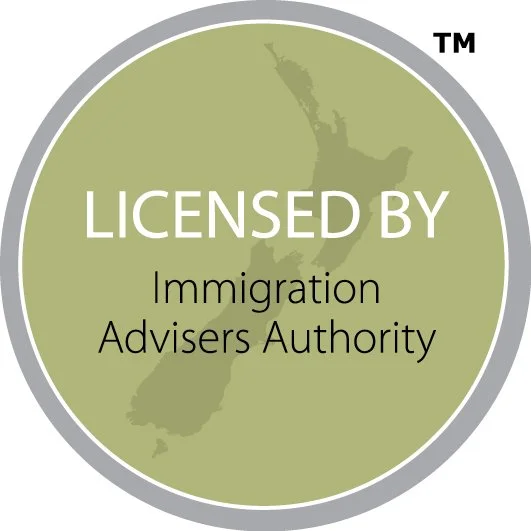 A circular badge with a green background showing a map of New Zealand in darker green. Text in the center reads, 'LICENSED BY Immigration Advisers Authority,' with a gray border and a small TM symbol in the top right corner.