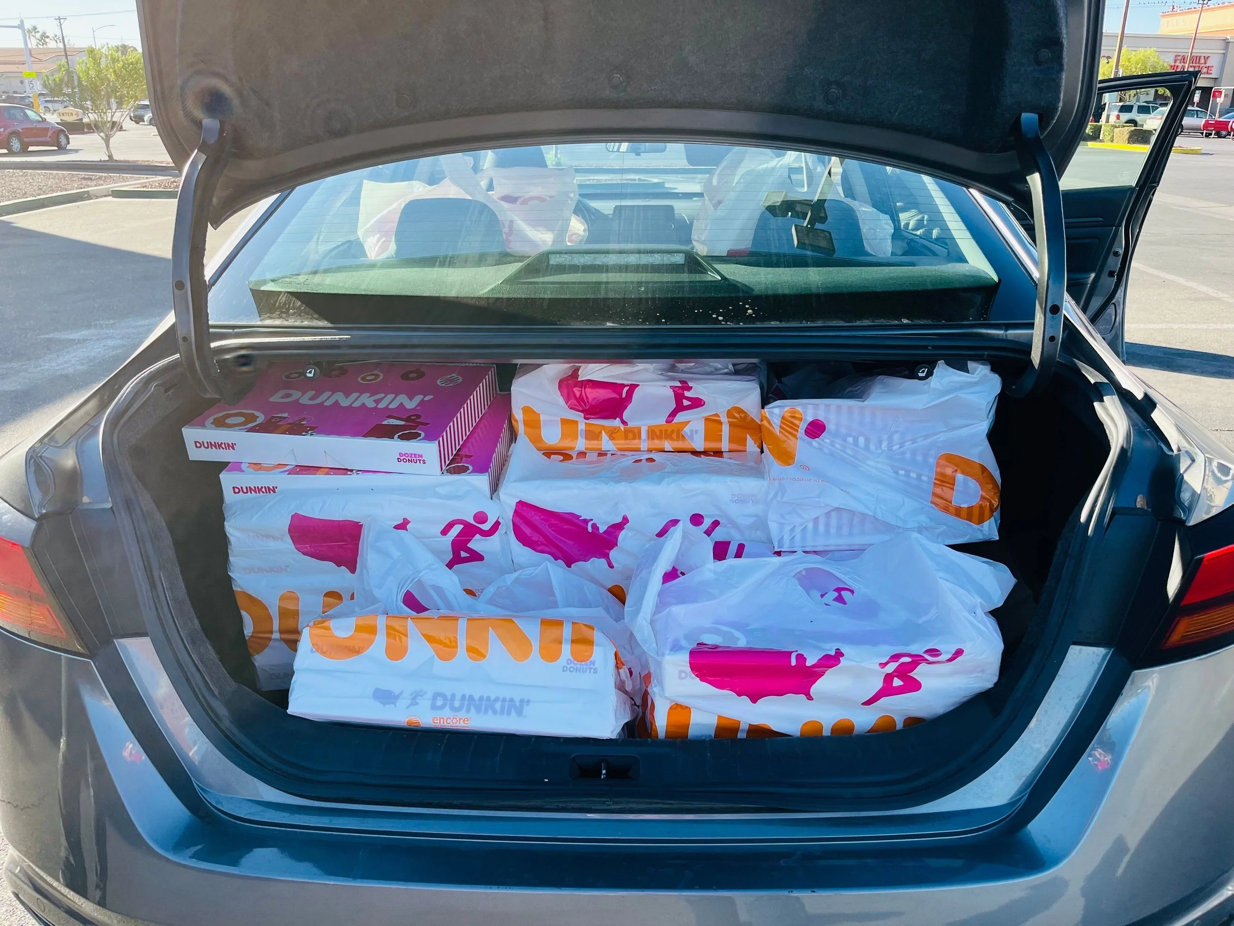car trunk full of donuts in boxes