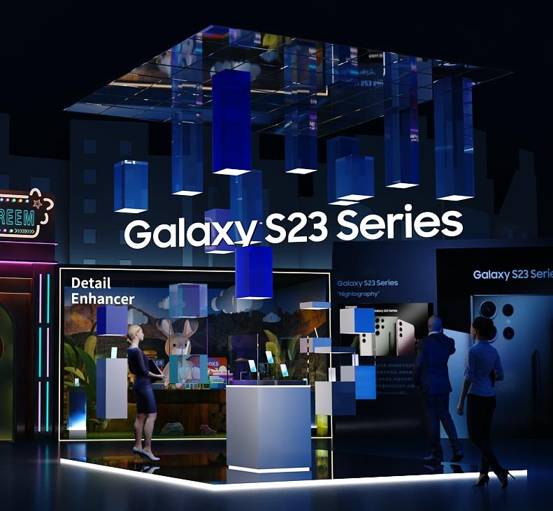 Interior of a Samsung Galaxy S23 Series display booth with blue lighting and attendees exploring the new smartphones.