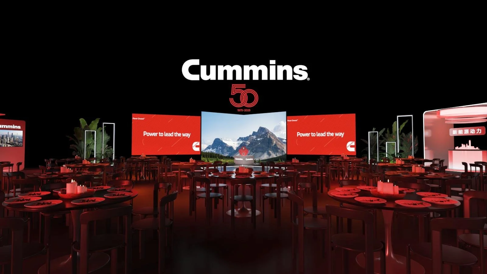 Event space decorated with a large black screen displaying 'Cummins 50 1975-2025' and two red screens with the message 'Power to lead the way,' with tables and chairs set for an event.