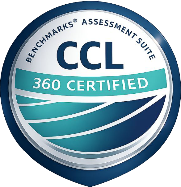 Close-up of a circular badge with blue, white, and teal colors, indicating 'CCL 360 Certified' by Benchmarks Assessment Suite.