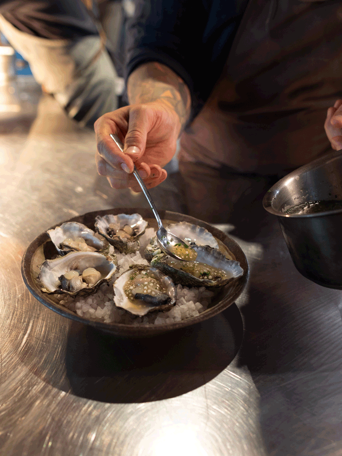 A chef plates up a half dozen oysters
