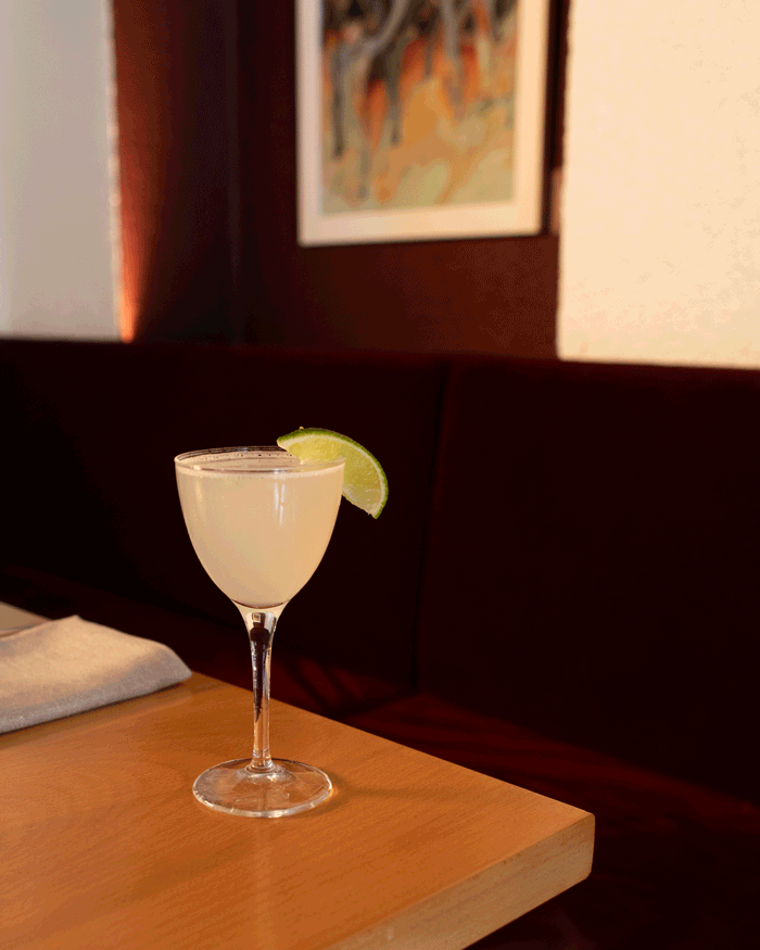 A margarita placed on the corner of a dining table at Aurora
