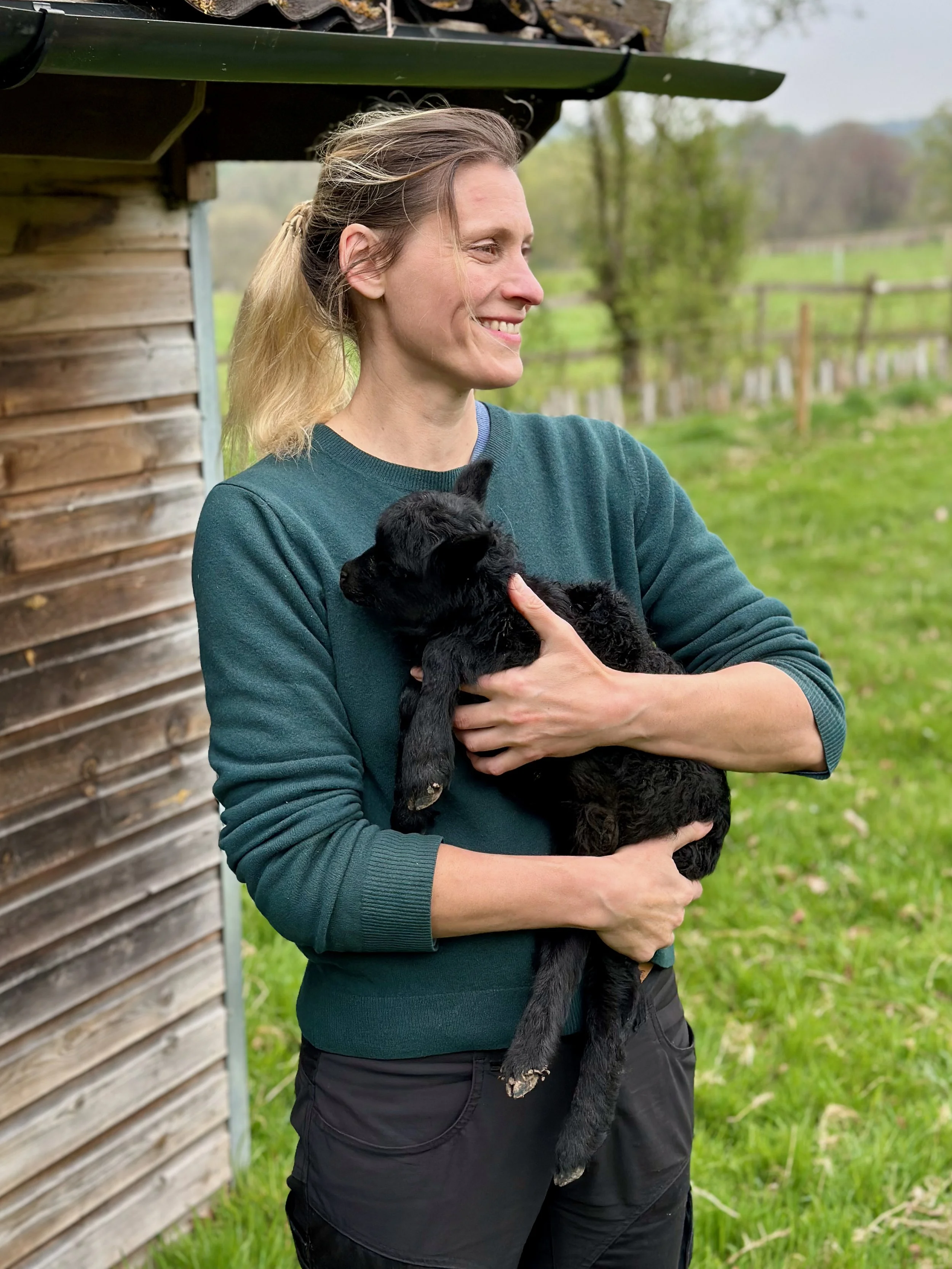 Eeva Kuisma at Sutton Mead with a Hebridean lamb.