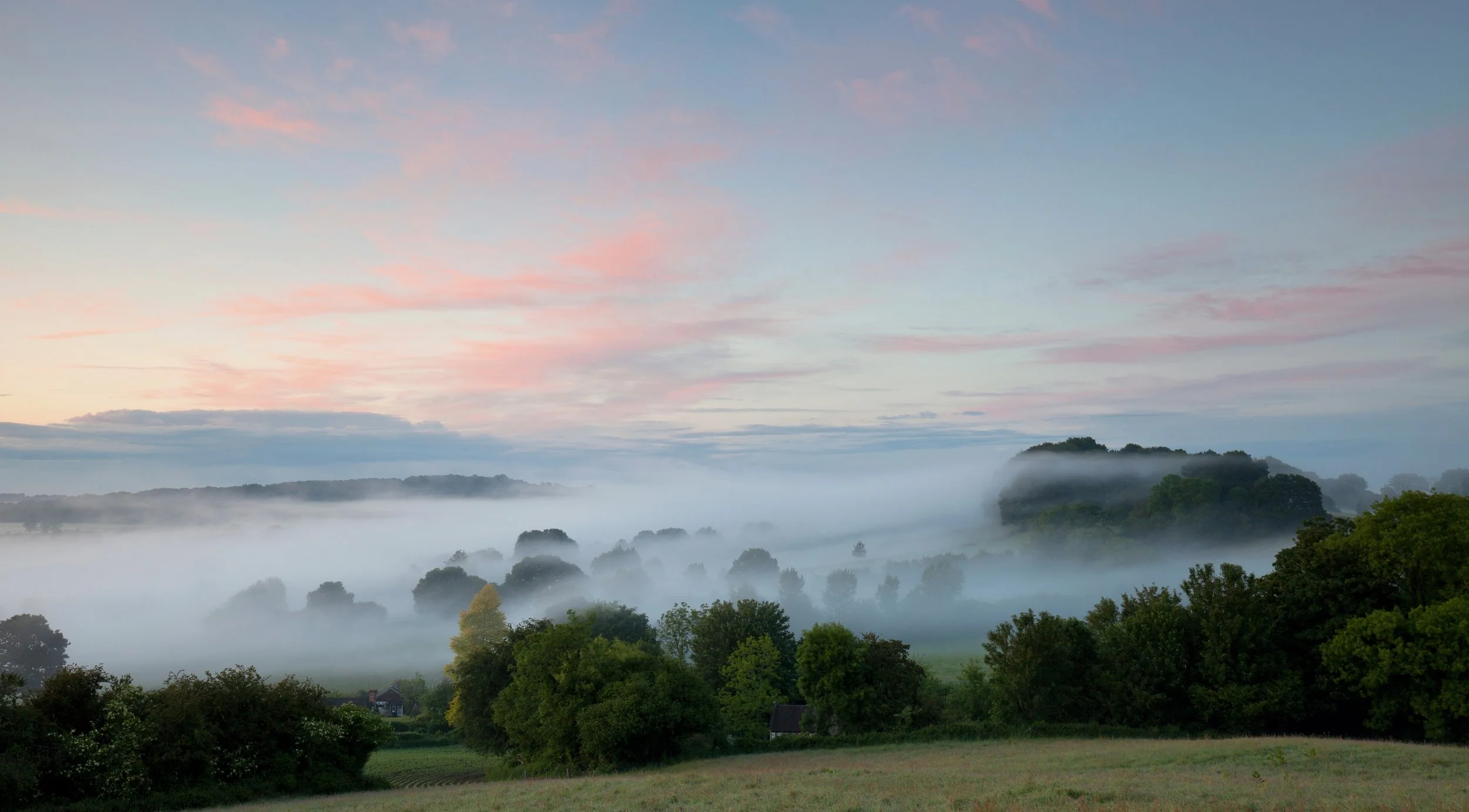 Evening mist across the Nadder Valley at Sutton Mead, Wiltshire.