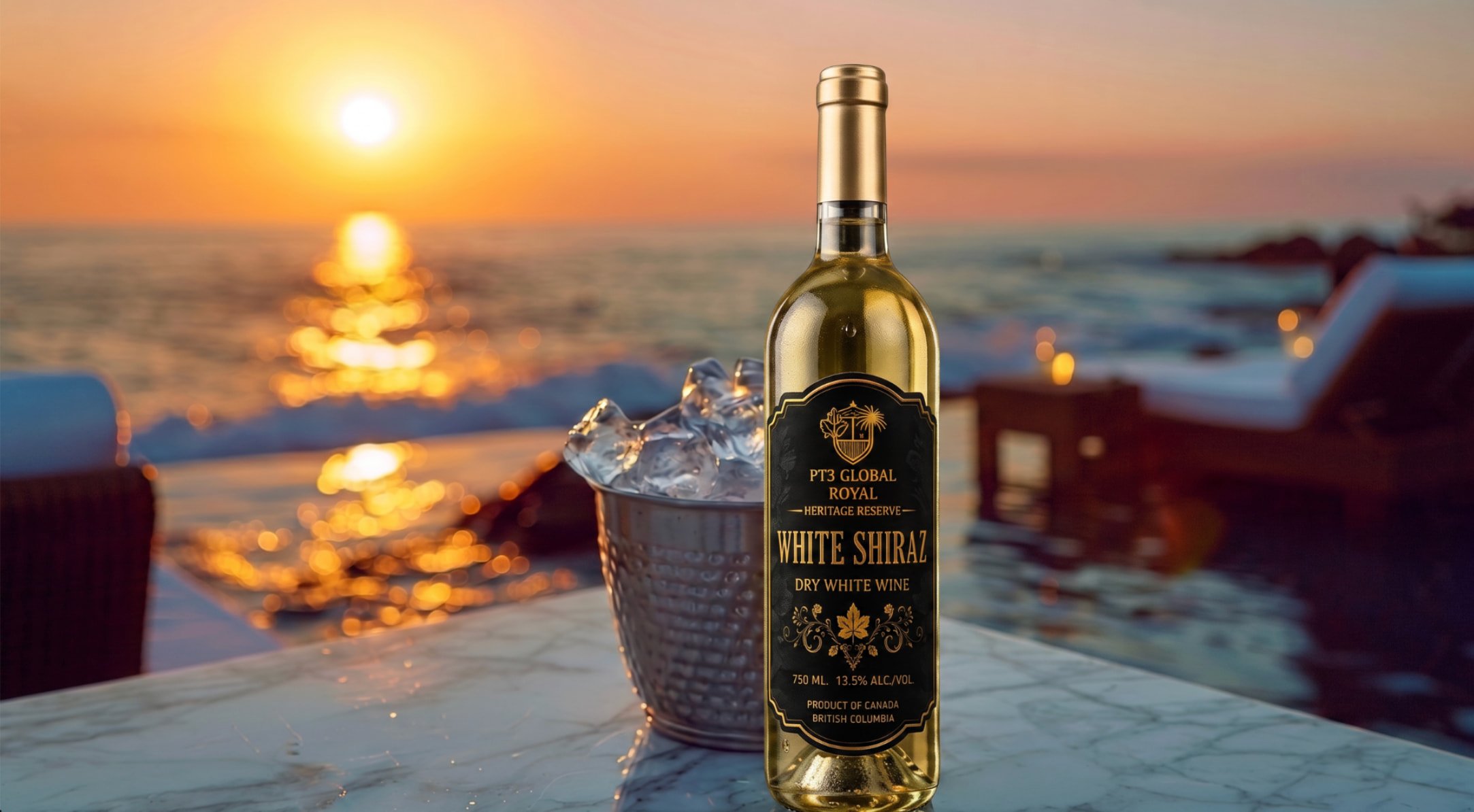 A bottle of white Shiraz wine in an ice bucket on a table outdoors during sunset, with the ocean and a sunset sky in the background.
