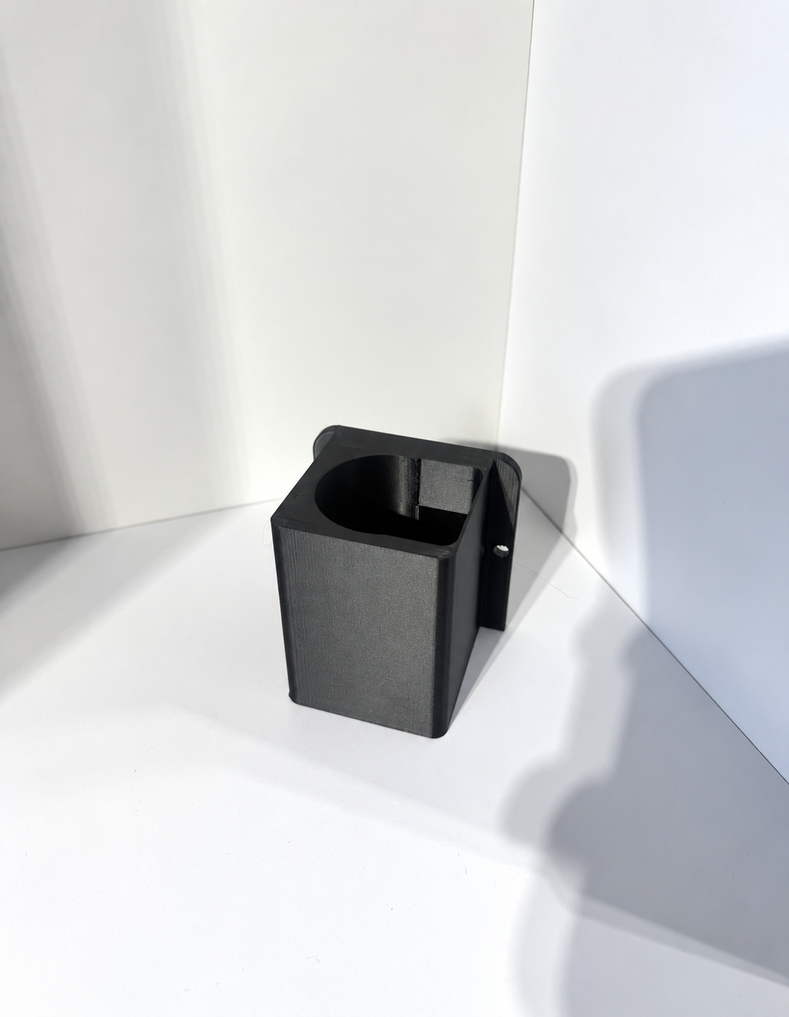 Black 3D-Printed Bracket in White Lightbox.png