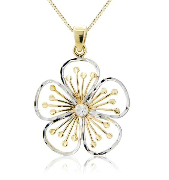 Gold and silver flower pendant necklace with a clear gemstone at the center.
