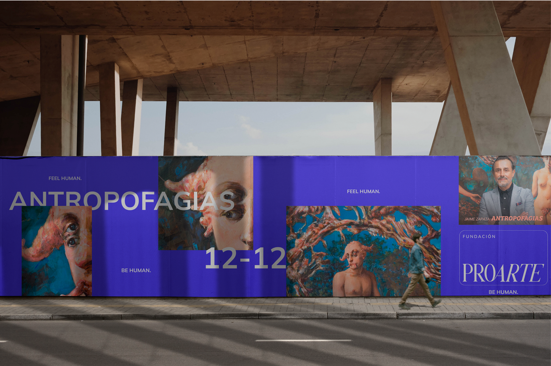 Cartel publicitario con obras de arte y el texto 'ANTROPOFAGIAS', 'FEEL HUMAN', 'PROARTE' en color azul y letras blancas, con una fecha '12-12' y una foto de un hombre de cabello encanecido y barba, en un entorno urbano bajo una estructura de concreto.