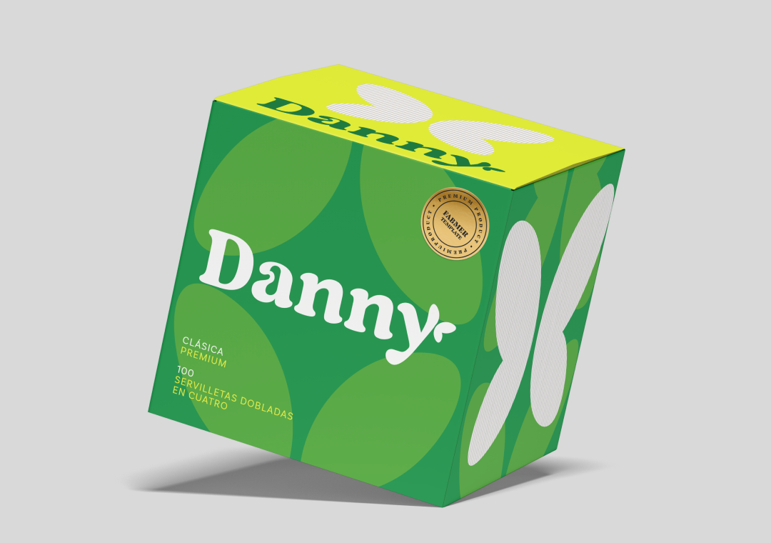 Caja de galletas Dany con diseño en tonos verdes y amarillos, con letras blancas, y un sello dorado que indica calidad premium.