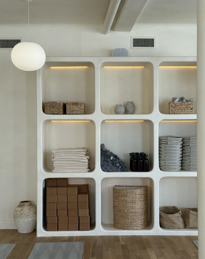 Custom millwork and interior improvement project completed by Conquest Management, featuring built-in shelving and storage solutions for a commercial workspace.