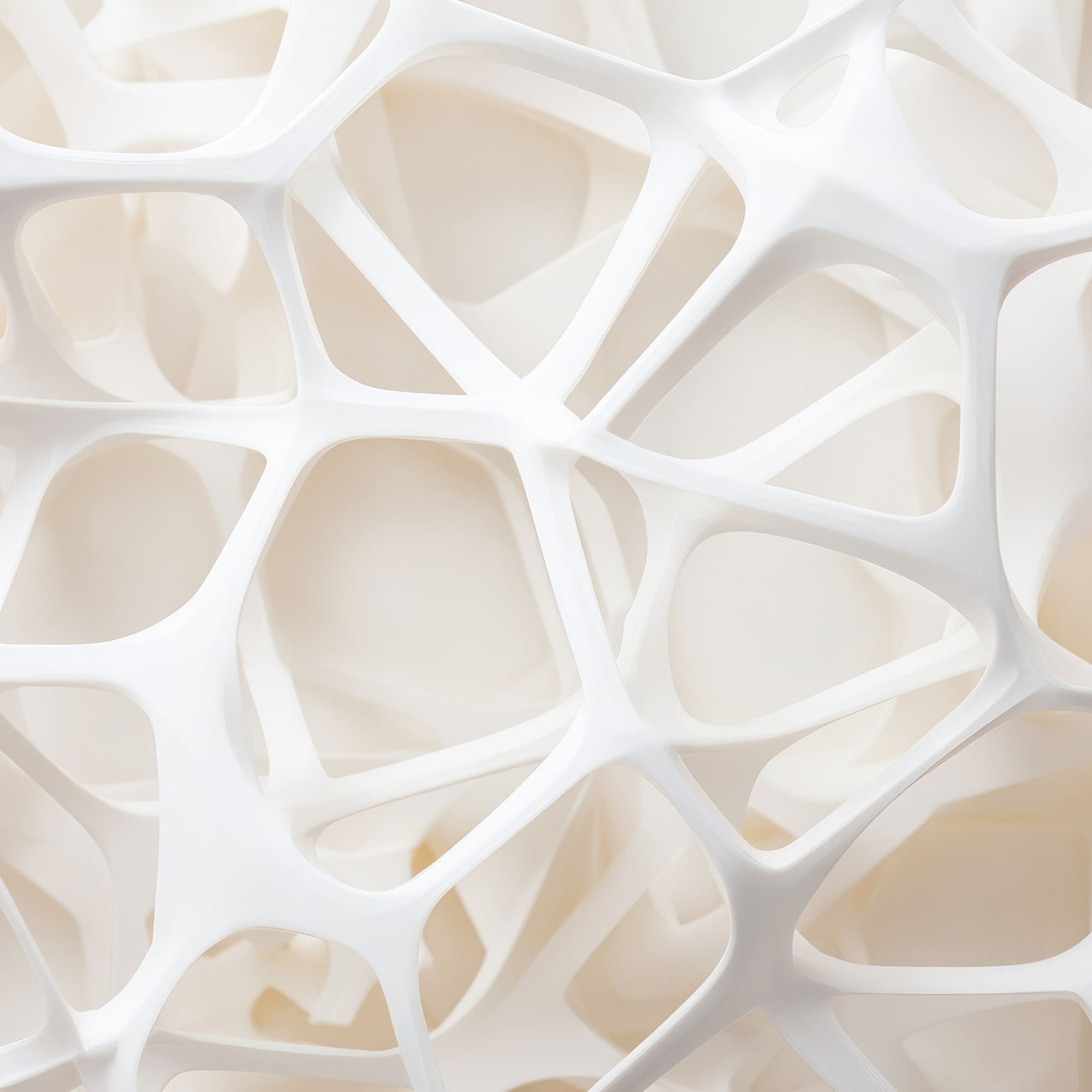 Close-up of an intricate white 3D-printed geometric lattice structure with interconnected oval and rectangular openings.