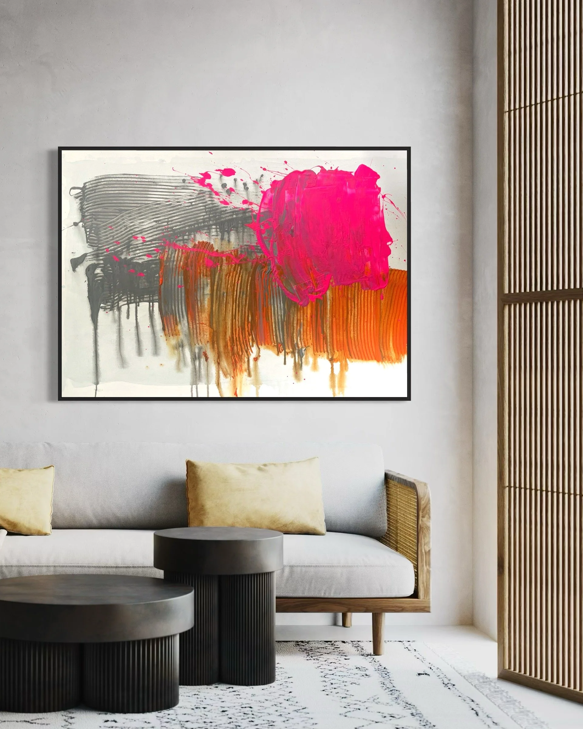Living room with modern white sofa, yellow pillows, black round coffee tables, abstract artwork with pink, black, and orange paint on wall, and wooden slat room divider.