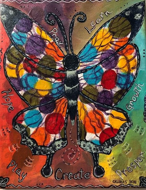 Colorful butterfly with words around it: "Dream," "Learn," "Grow," "Prove," "Create," "Play," and "Hope."