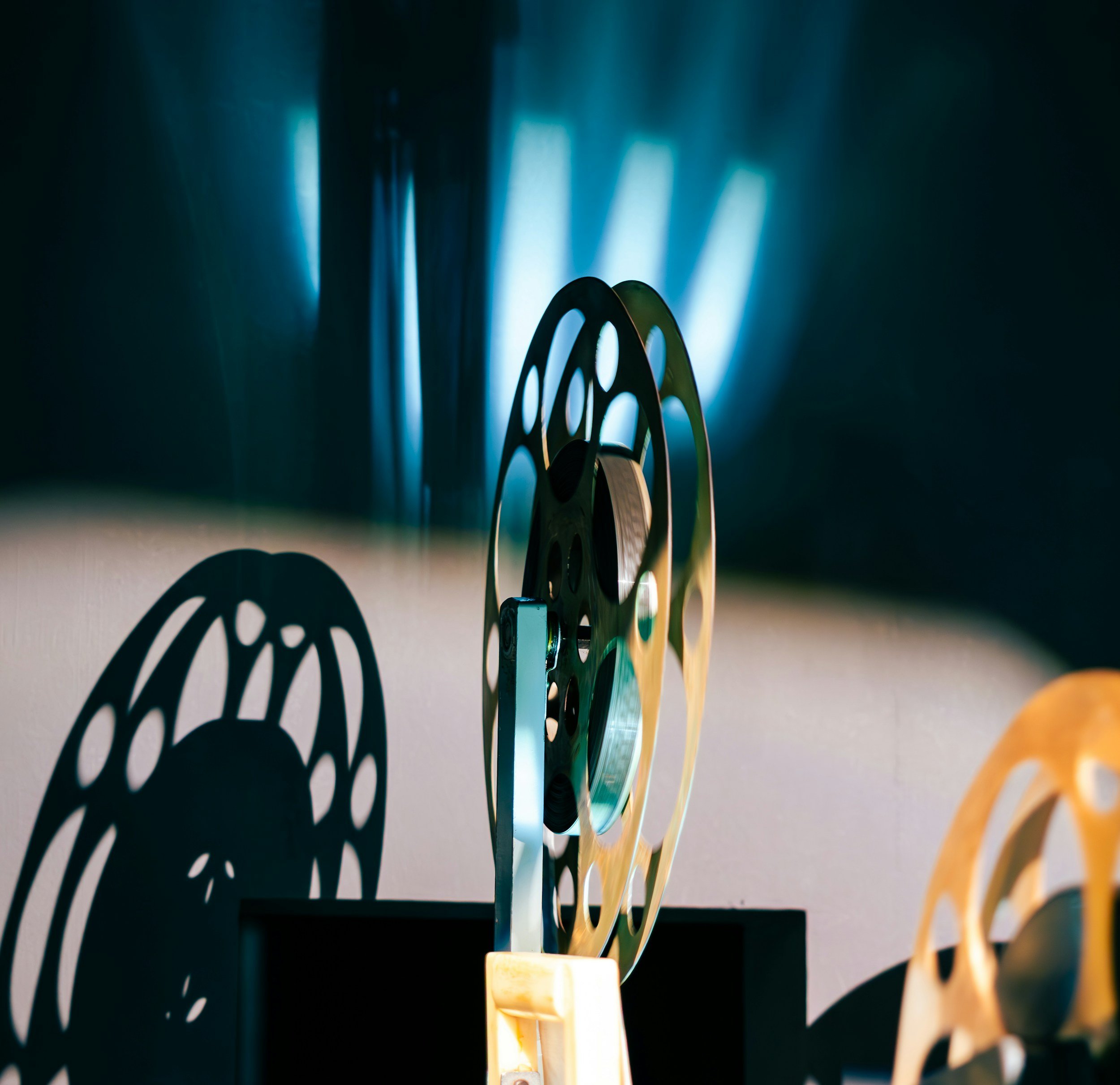 Close-up of film reels with a blue glow in the background.