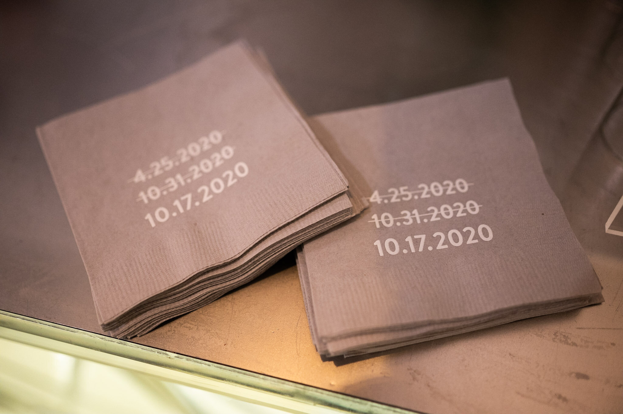 Stack of pink paper tickets with dates printed on them, including April 25, 2020, October 31, 2020, and October 17, 2020.