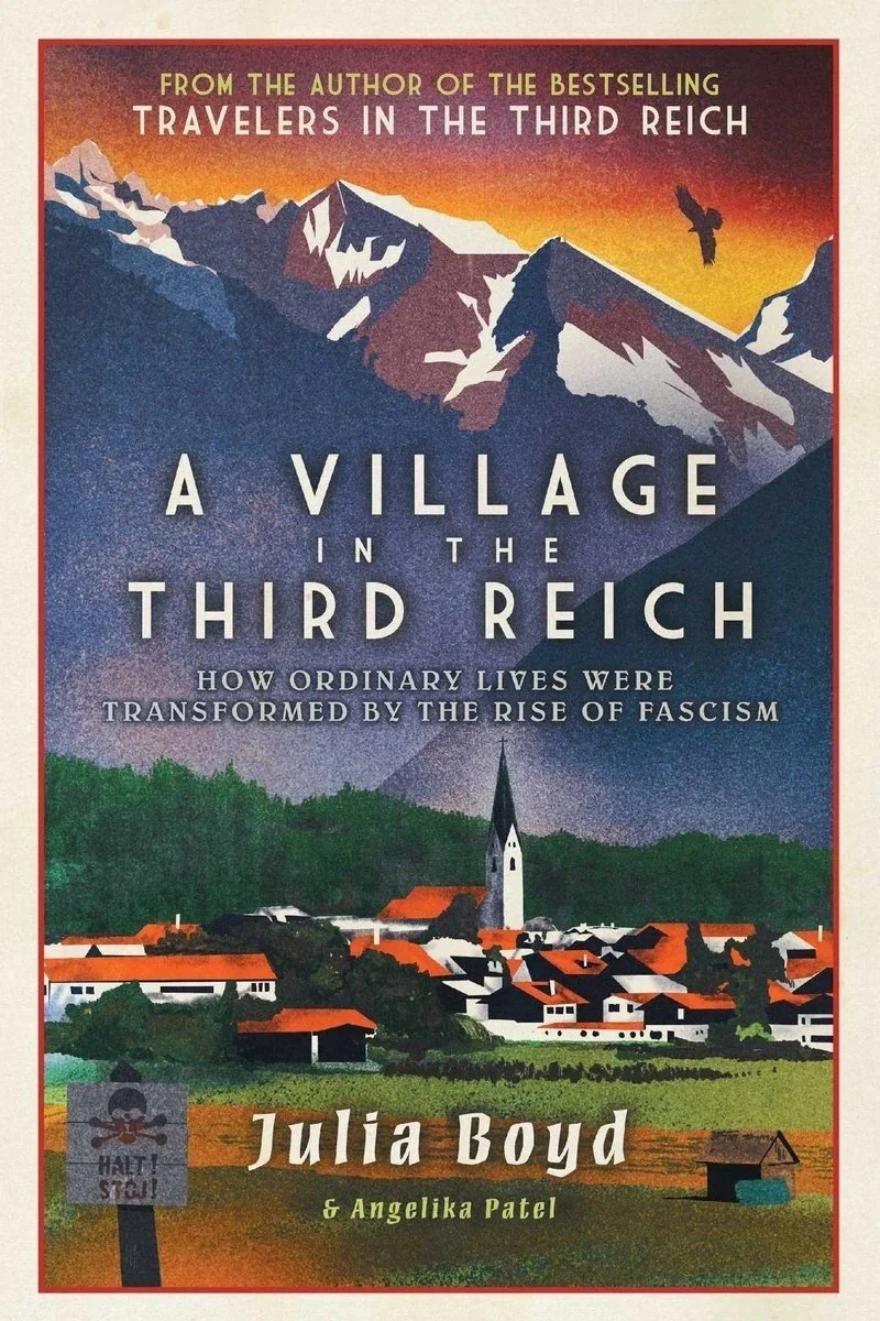Book cover titled "A Village in the Third Reich" by Julia Boyd with co-author Angelika Patel. The cover features a mountain landscape with a bird flying and a village with houses and a church. The subtitle reads "How ordinary lives were transformed by the rise of fascism."