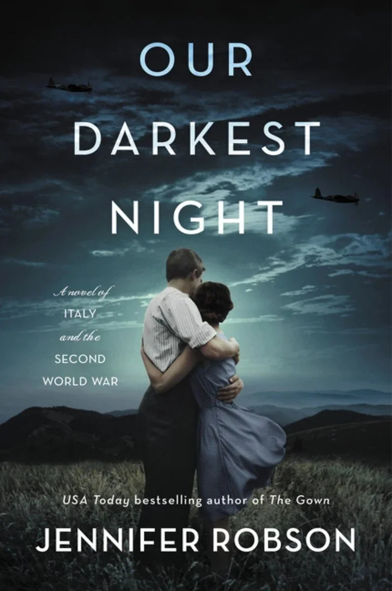 Book cover for 'Our Darkest Night' by Jennifer Robson, depicting a vintage photograph of a boy and girl embracing in a field, with a dark, cloudy sky and planes flying overhead.