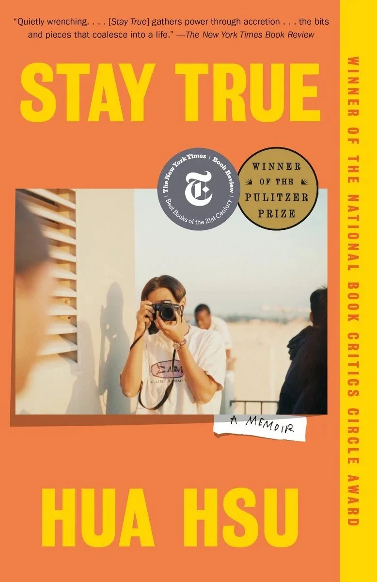 Book cover titled 'Stay True' by Hua Hsu featuring a person holding a camera, with award mentions from The New York Times and Pulitzer Prize, and a quote about gathering power through accretion.