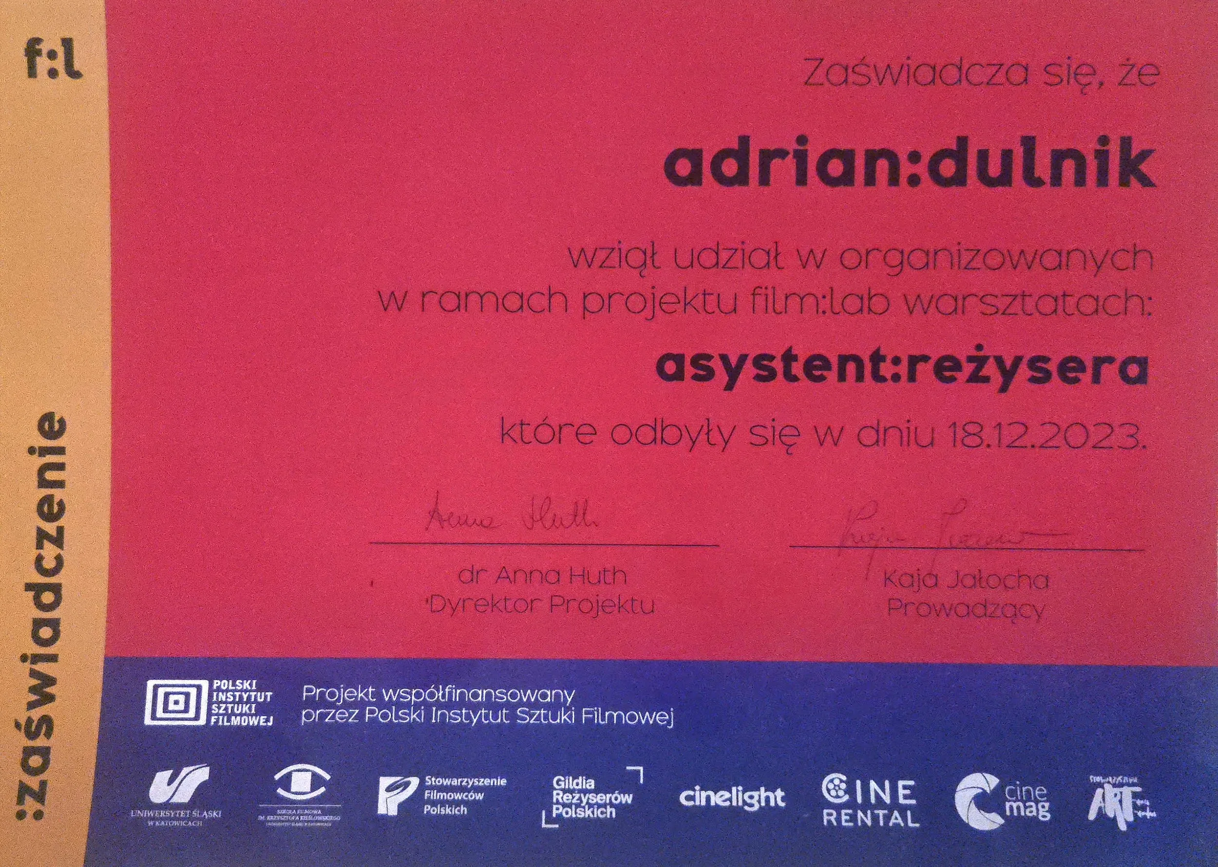 A colorful certificate or award with text in Polish and logos at the bottom, including Polskie Instytut Sztuki Filmowej and other organizations.
