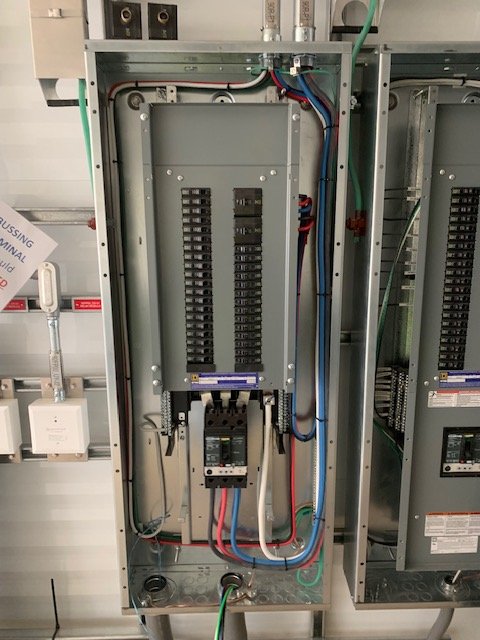 Electrical panel with circuit breaker and wiring inside metal enclosure