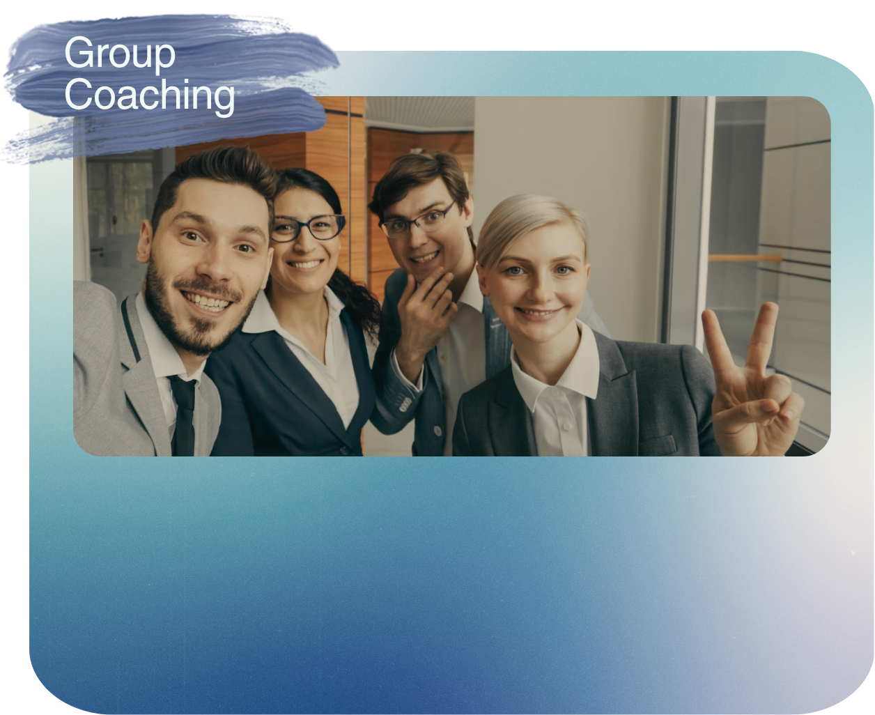 Group of four young professionals taking a selfie together in a modern office, with one woman showing a peace sign.