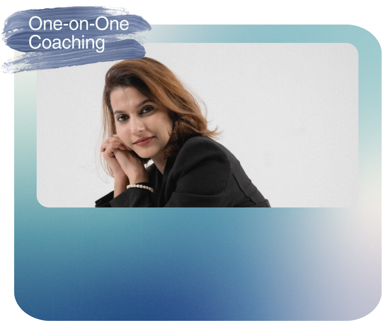Woman with shoulder-length brown hair wearing black blazer, sitting with her hand under her chin, smiling at the camera. Text overlay reads 'One-on-One Coaching.'