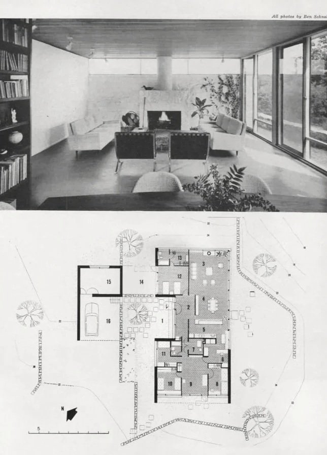 Living room with large windows, built-in bookshelves, and modern furniture, with a floor plan of a house below.
