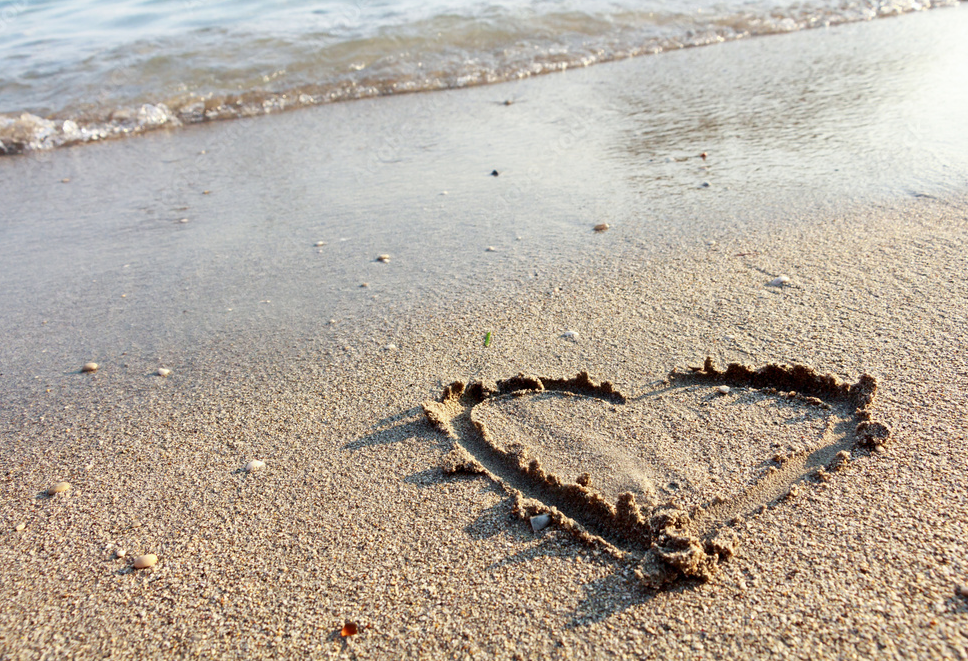 Heart drawn in beach sand.png
