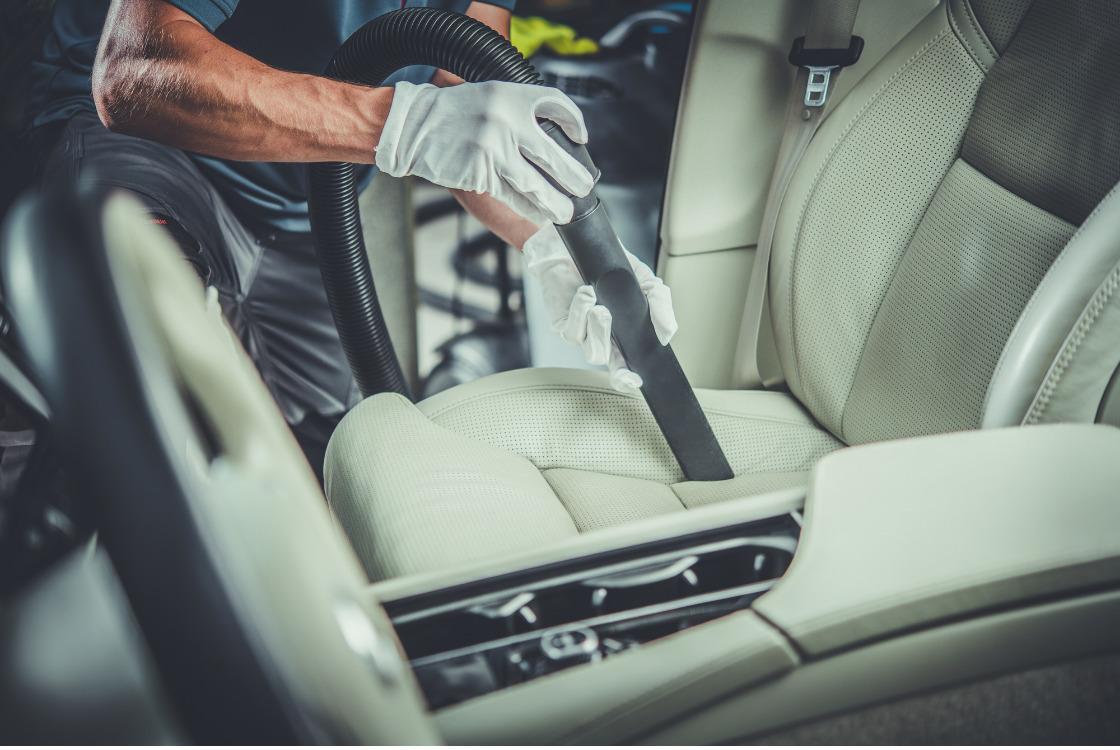 Professional steam cleaning and sanitizing of car seats during a premium interior detailing service in Ocala, FL